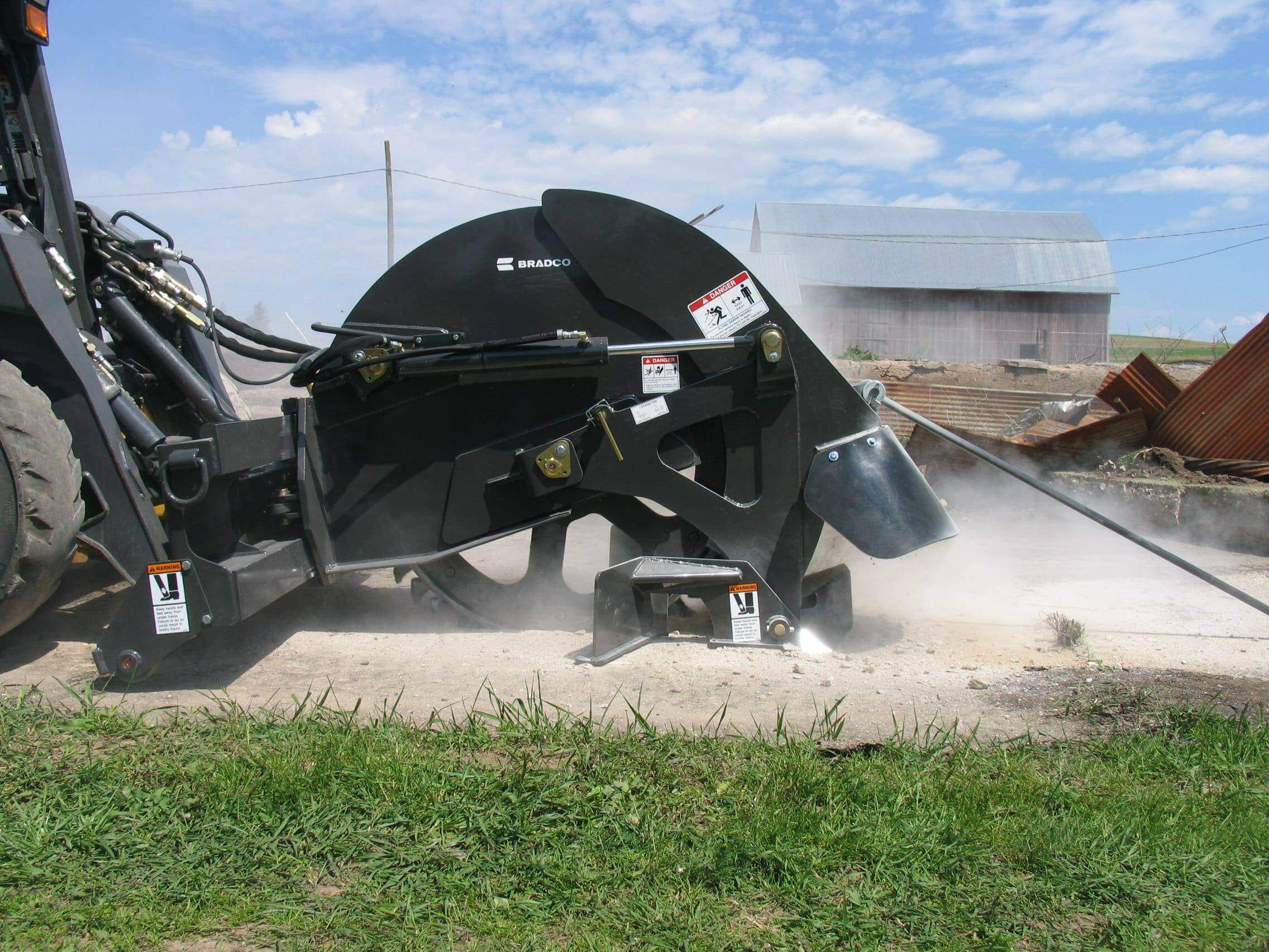 Skid steer rock saw attachments